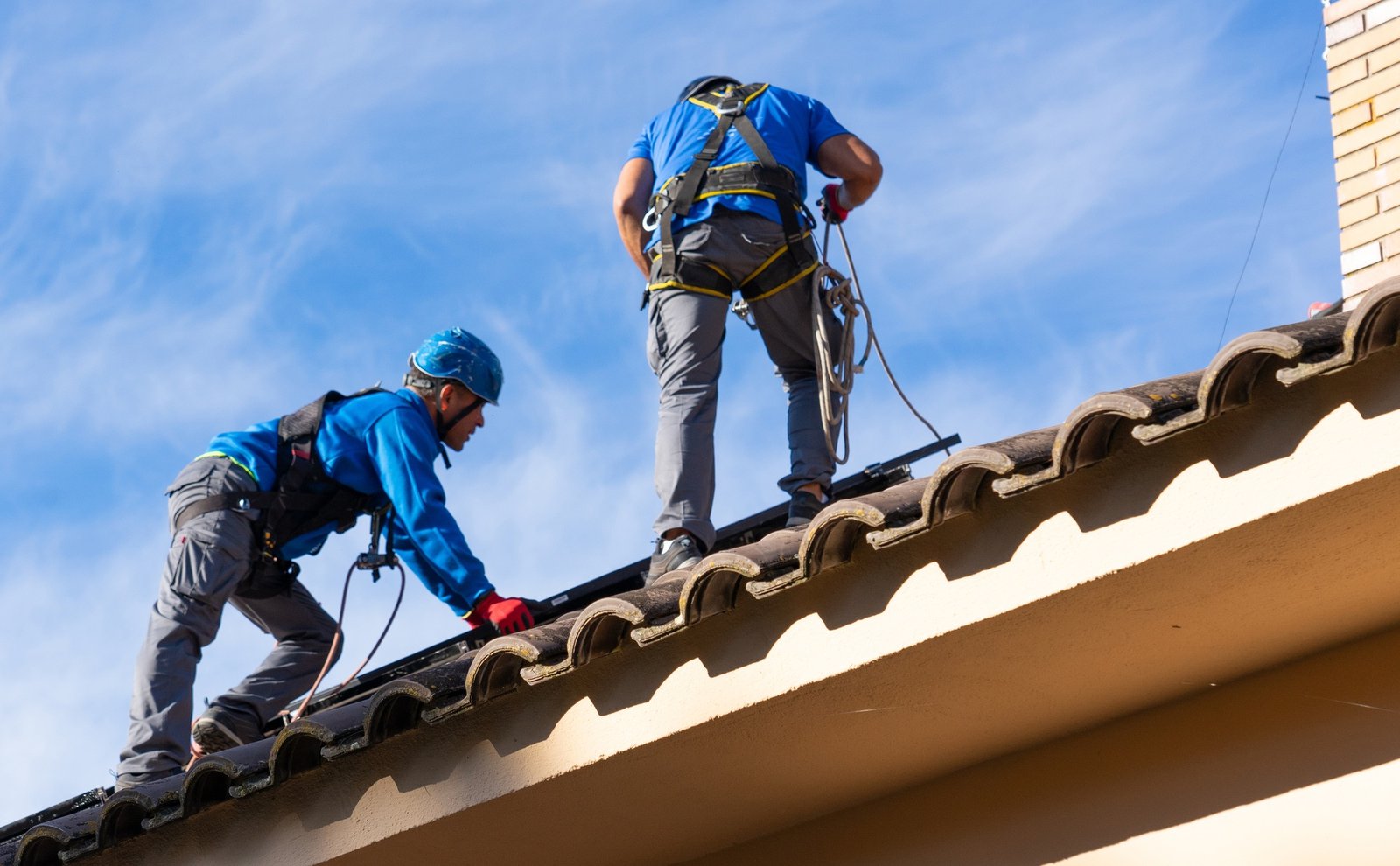 Men installing solar panels on the roof